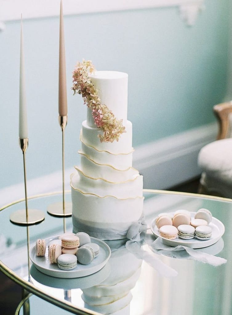 White and gold ruffle wedding cake with pink and grey macarons at 10-11 Carlton House Terrace